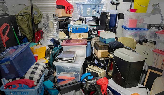Cluttered room filled with stacked hoarding items