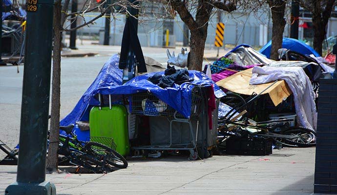 Homeless encampment tents and belongings on sidewalk