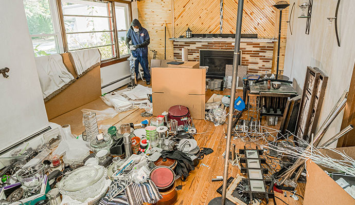 A professional cleaning hoarded room that filled with clutter
