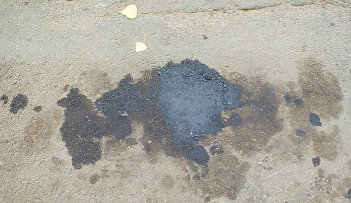 Chemical spill on a concrete surface with visible staining and residue