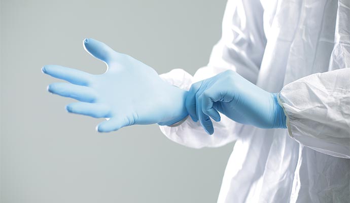 A person wearing nitrile gloves