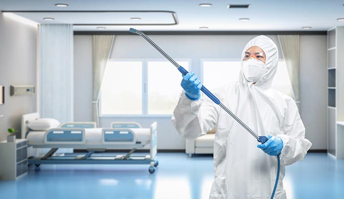 A professional disinfecting hospital room with equipment