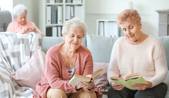 Senior women reading books in an assisted living facility