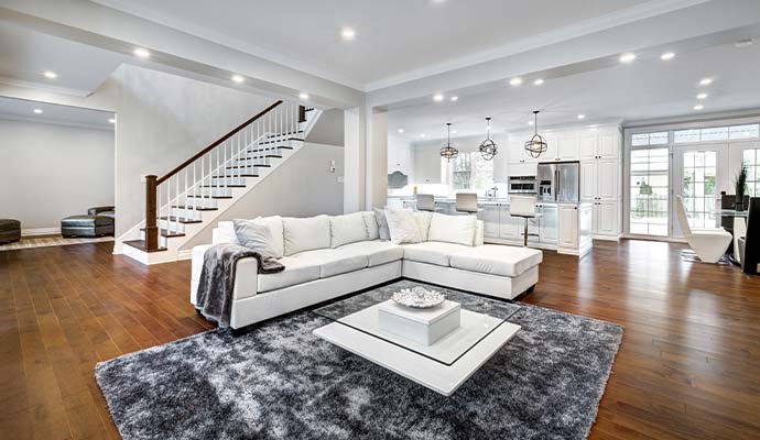 Clean restored living room with white sectional sofa