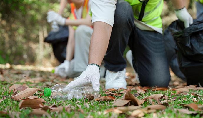 Trauma scene cleaners picking up plastic bottle