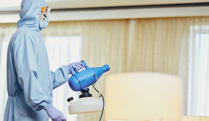 Technician holding fogger machine for odor treatment